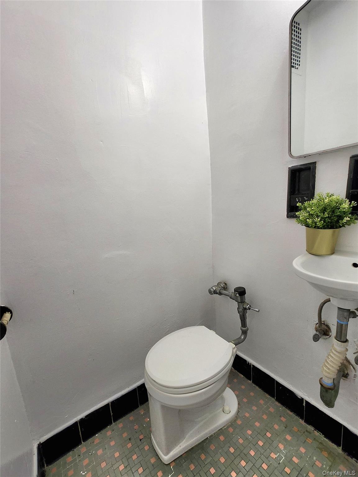 33-27 91st Street, Unit 1J Queens, NY 11372 - Photo 12 of 27 a white toilet sitting next to a sink