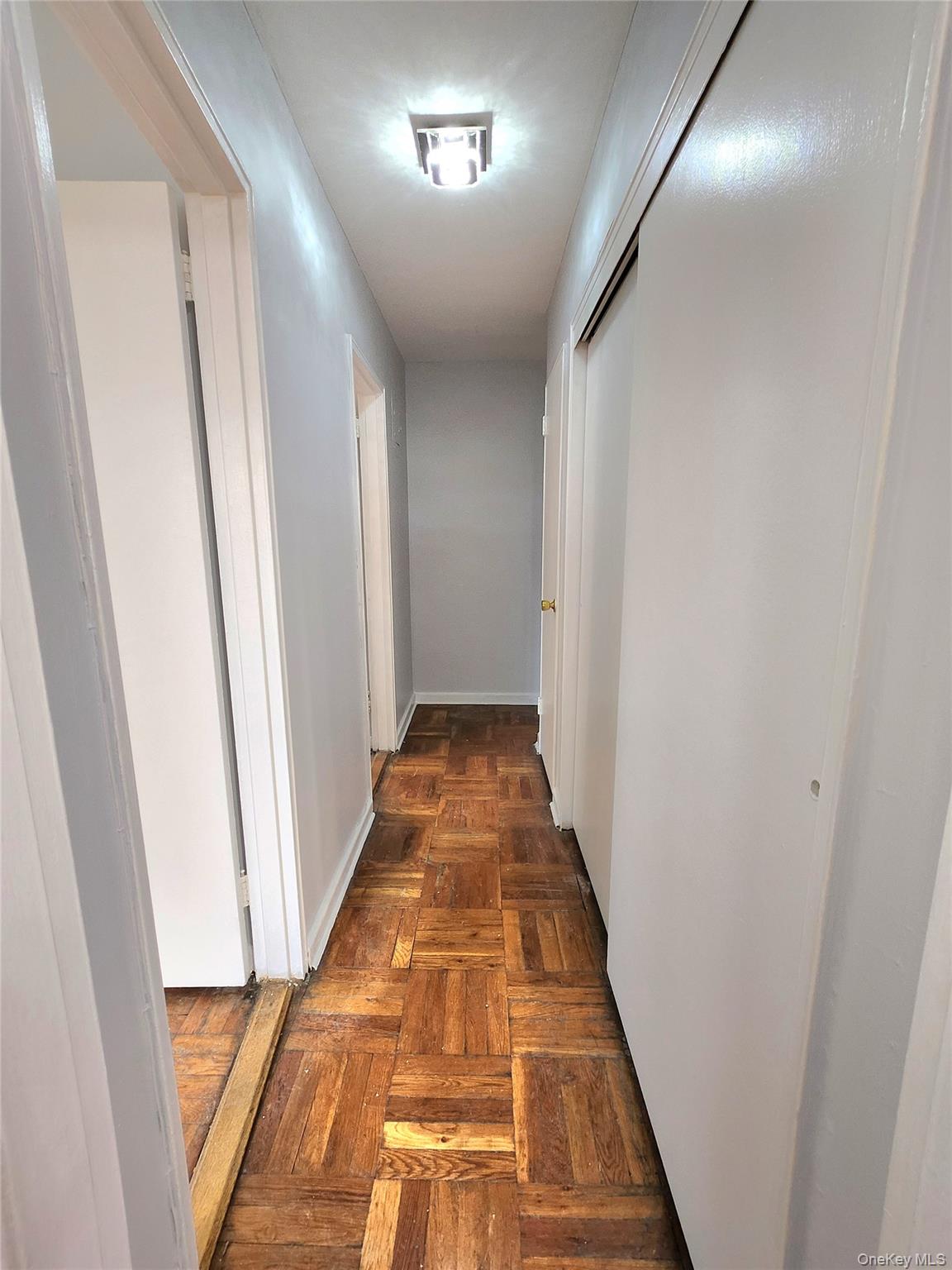 33-27 91st Street, Unit 1J Queens, NY 11372 - Photo 13 of 27 a view of hallway with wooden floor