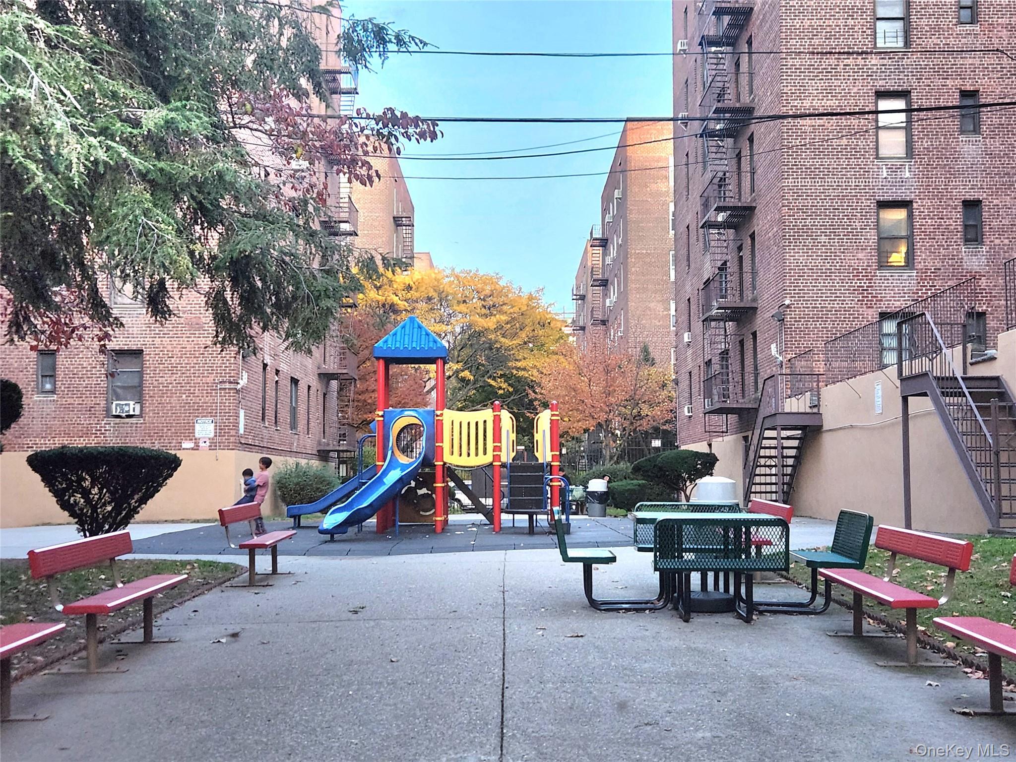 33-27 91st Street, Unit 1J Queens, NY 11372 - Photo 23 of 27 a childrens park with lots of swings and slides