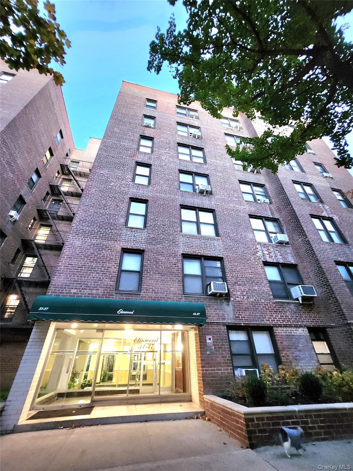 33-27 91st Street, Unit 1J Queens, NY 11372 - Photo 24 of 27 a view of multiple houses with a yard