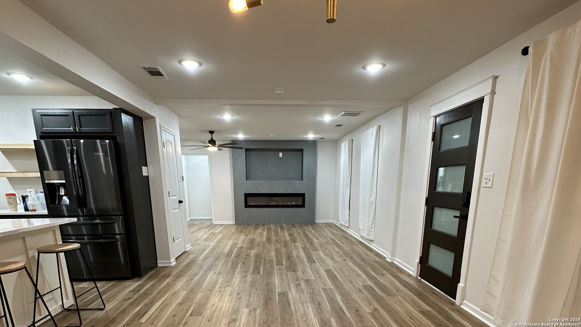 210 County Road 4643 Hondo, TX 78861 - Photo 4 of 13 wooden floor in an empty room with a kitchen