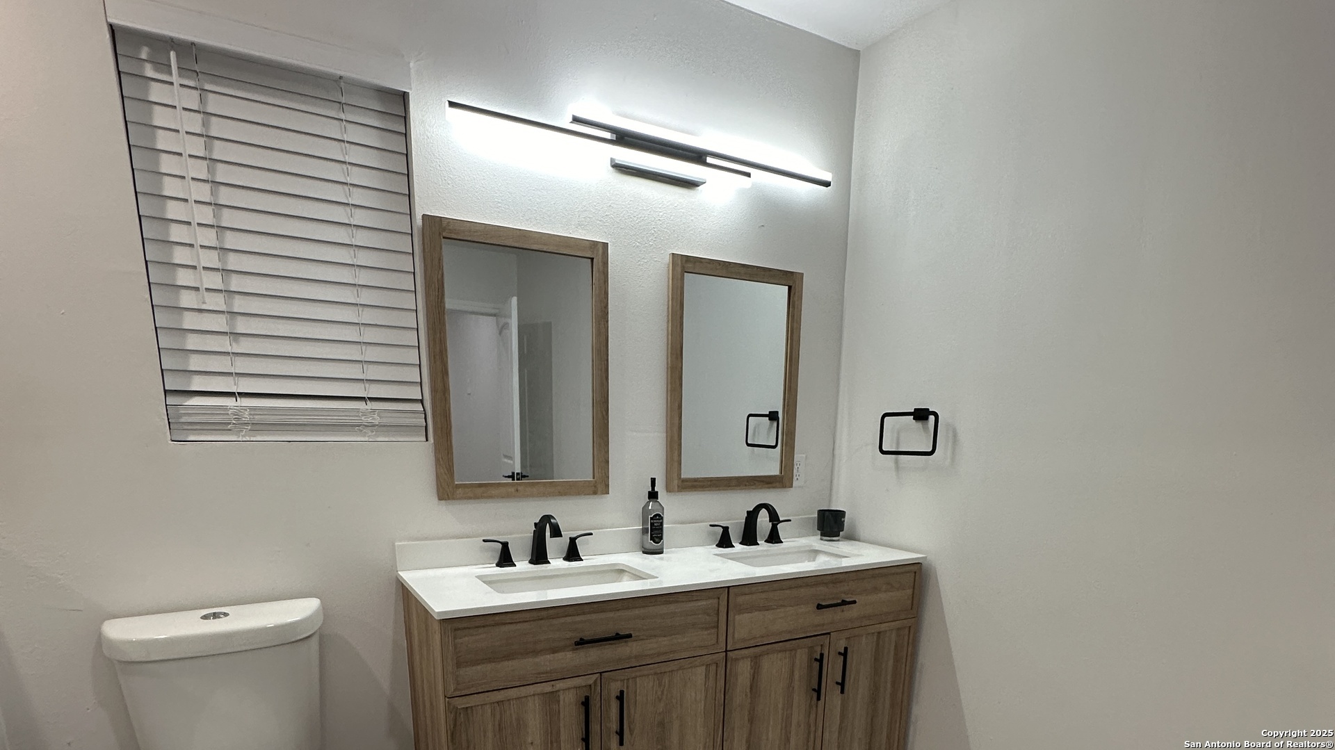 210 County Road 4643 Hondo, TX 78861 - Photo 8 of 13 a bathroom with a toilet sink and mirror