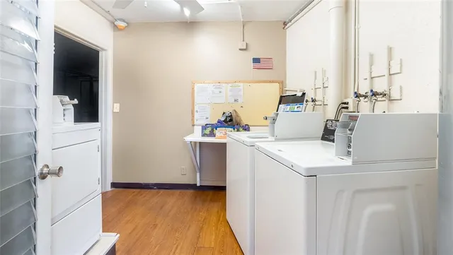 a view of washer and dryer with kitchen in the background
