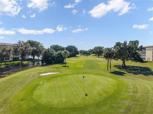 a view of an swimming pool and trees in the background