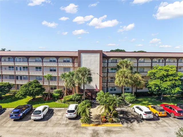 a front view of a house with a garden and plants