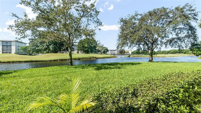 a view of yard with swimming pool and trees