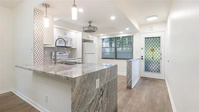 a kitchen with counter top space cabinets and wooden floor