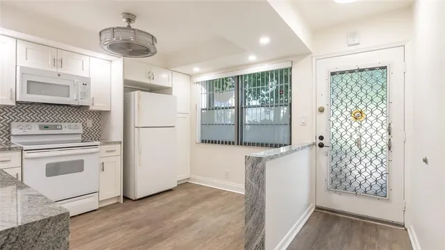 a kitchen with stainless steel appliances a refrigerator and a stove top oven