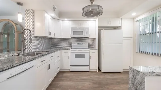 a kitchen with appliances cabinets and a sink