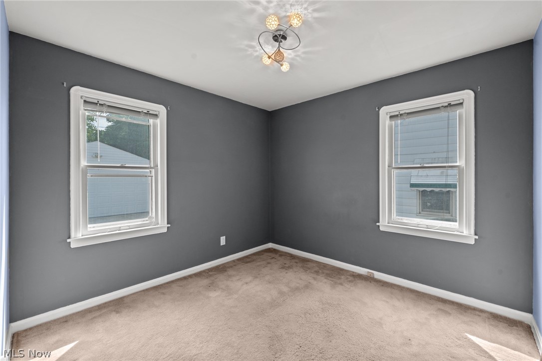 3261 Berea Road Cleveland, OH 44111 - Photo 11 of 43 Recessed ceiling lighting, two windows with white trim, and light-toned carpeting