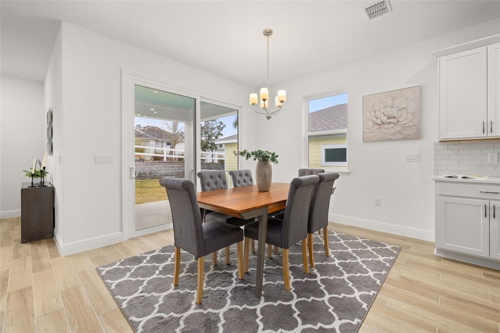 995 Fiesta Key Circle Lady Lake, FL 32159 - Photo 8 of 38 a view of a dining room with furniture window and wooden floor