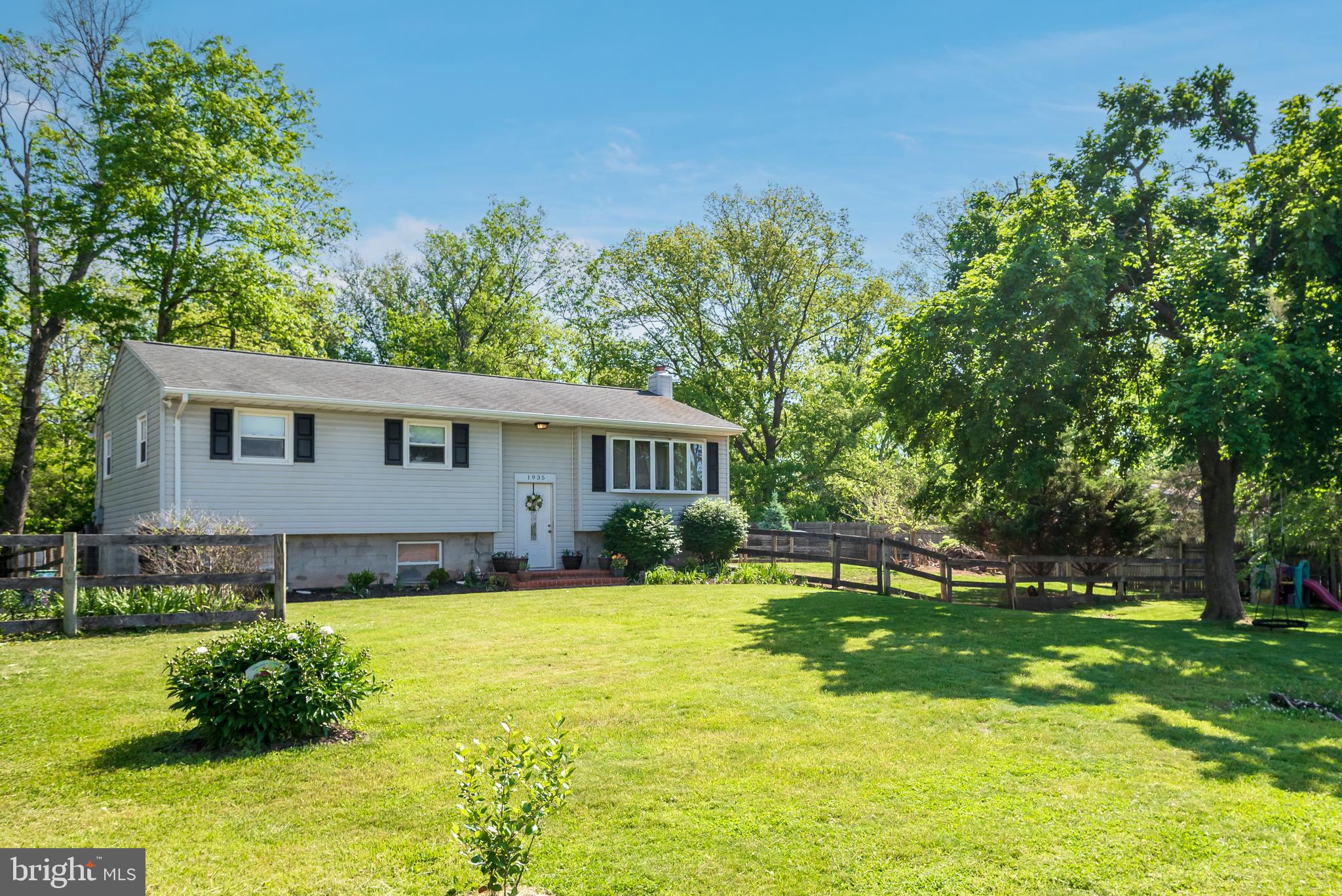 1935 Trevanion Road Taneytown, MD 21787 - Photo 1 of 1 a view of a house with a big yard and potted plants and large trees