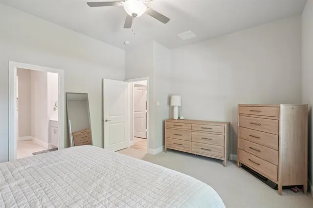 a bedroom with a bed and a dresser