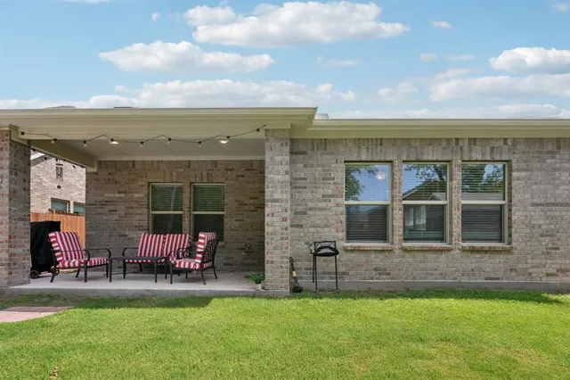 a view of a house with backyard porch and sitting area