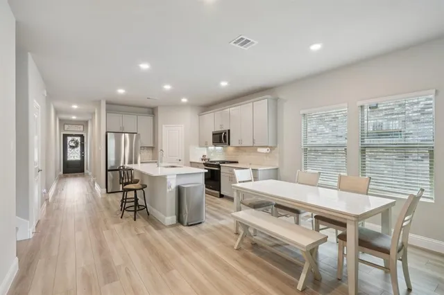 a large kitchen with a table and chairs in it