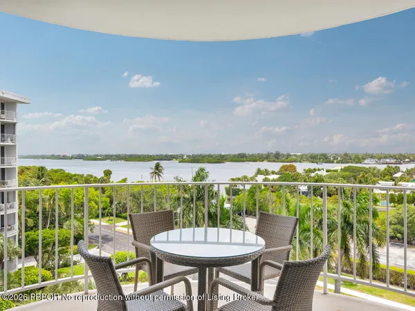 a view of a chairs and table in a balcony