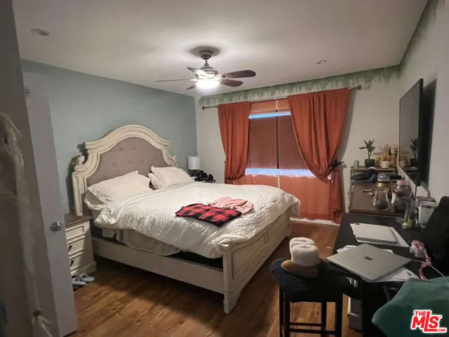 a bedroom with a bed and a flat screen tv