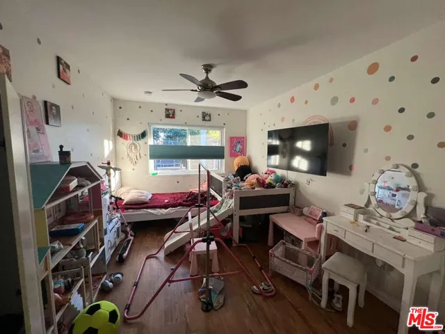 a view of a workspace with furniture and a flat screen tv