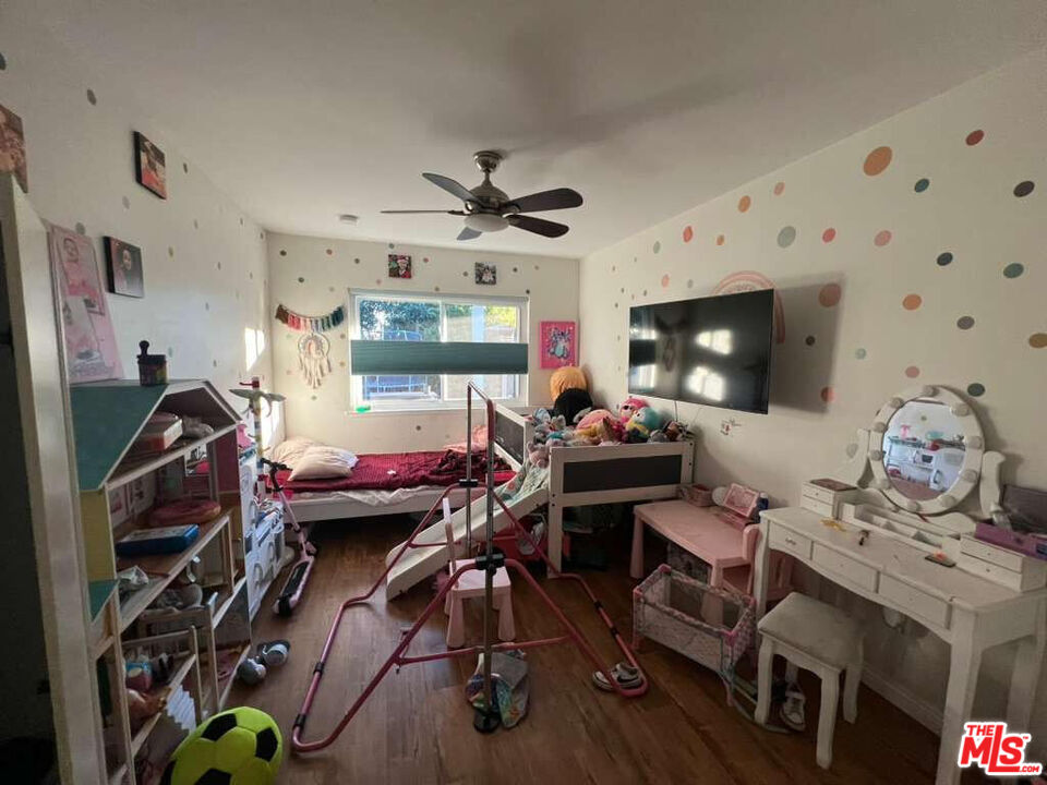 17014 Rinaldi Street Granada Hills, CA 91344 - Photo 12 of 16 a view of a workspace with furniture and a flat screen tv