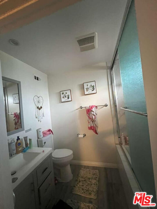 17014 Rinaldi Street Granada Hills, CA 91344 - Photo 13 of 16 a bathroom with a toilet sink and mirror