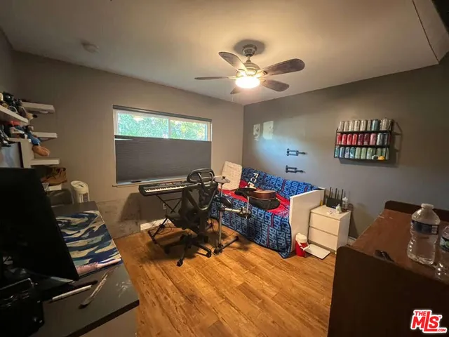 a living room with furniture a flat screen tv and a window