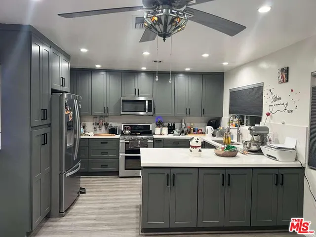 a kitchen with a sink stainless steel appliances and cabinets