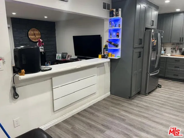 a kitchen with a refrigerator and a table