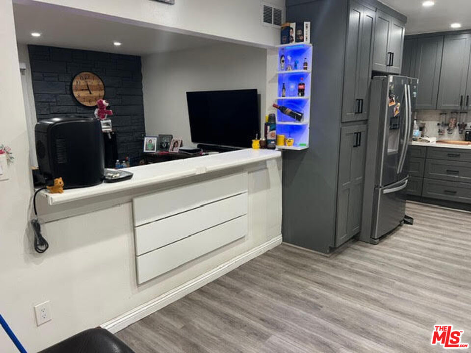 17014 Rinaldi Street Granada Hills, CA 91344 - Photo 4 of 16 a kitchen with a refrigerator and a table