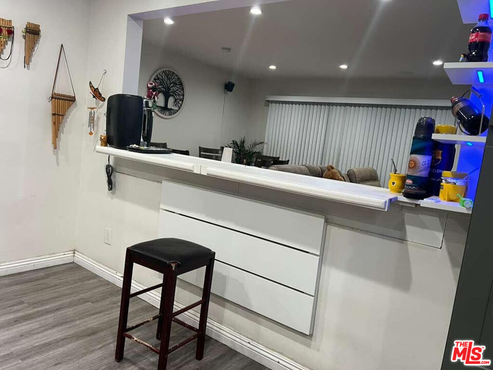 17014 Rinaldi Street Granada Hills, CA 91344 - Photo 6 of 16 a kitchen with a sink cabinets and wooden floor