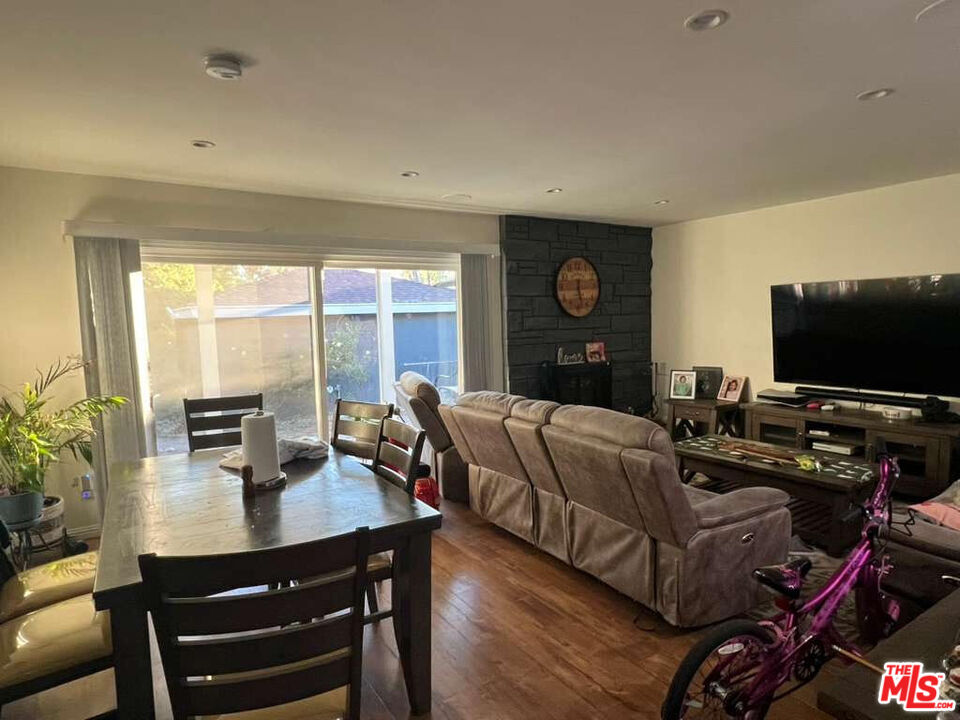 17014 Rinaldi Street Granada Hills, CA 91344 - Photo 9 of 16 a living room with furniture a flat screen tv and a large window