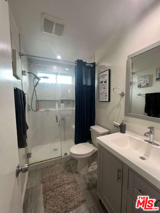 17014 Rinaldi Street Granada Hills, CA 91344 - Photo 10 of 16 a bathroom with a sink toilet and shower