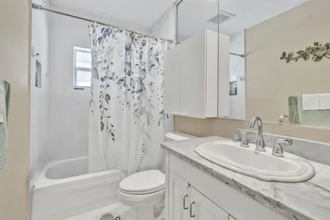 a bedroom with a bed and flat screen tv