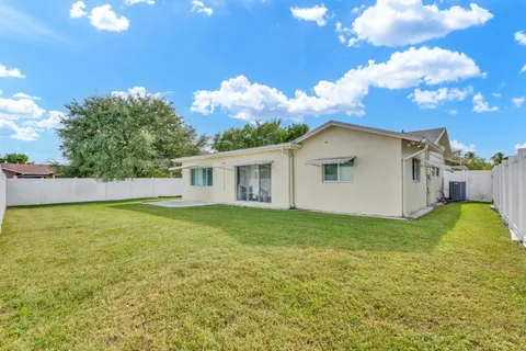 a view of a house with swimming pool and a yard