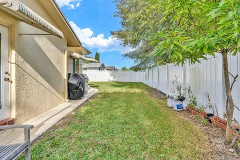 an aerial view of residential houses with yard