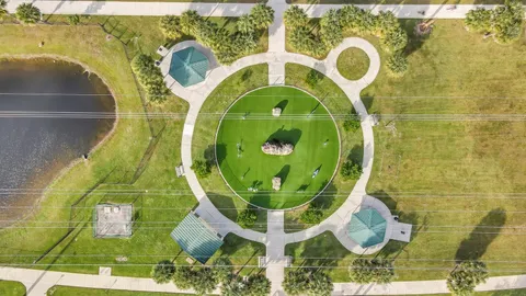 an aerial view of residential houses with yard