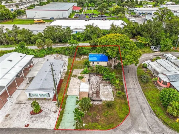 an aerial view of a house with garden space and lake view