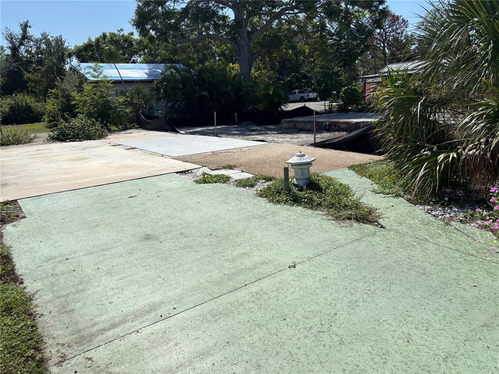 30 Hatchett Creek Road Venice, FL 34285 - Photo 7 of 17 a bench is sitting in middle of the yard