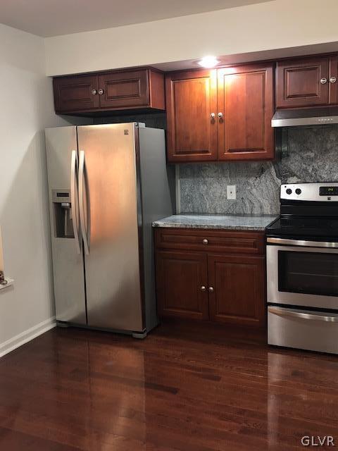 3423 Limestone Drive Whitehall, PA 18052 - Photo 3 of 10 a kitchen with stainless steel appliances granite countertop a stove a refrigerator and a microwave