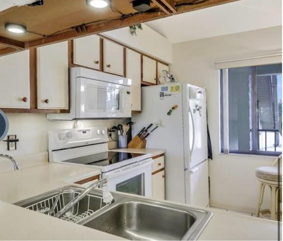 5419 Rattlesnake Hammock Road, Unit F204 Naples, FL 34113 - Photo 2 of 8 a kitchen with appliances cabinets and a sink