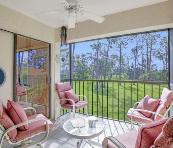 5419 Rattlesnake Hammock Road, Unit F204 Naples, FL 34113 - Photo 4 of 8 a living room with furniture and a floor to ceiling window