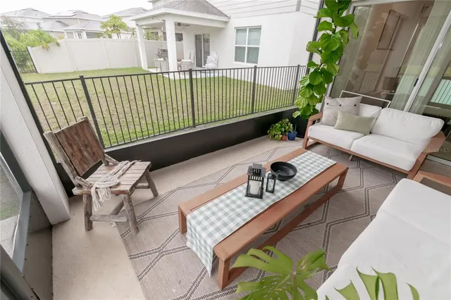 a view of a chair and tables in the balcony