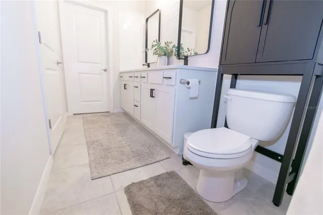 a bathroom with a sink a toilet and vanity