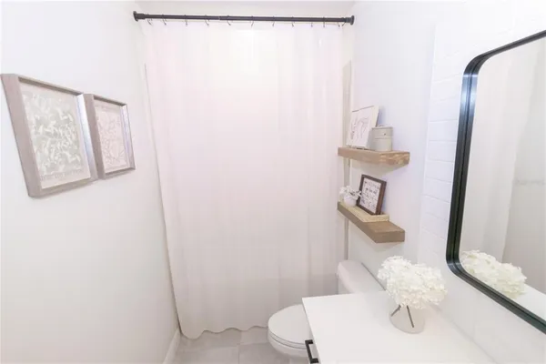 a bathroom with a sink toilet and mirror