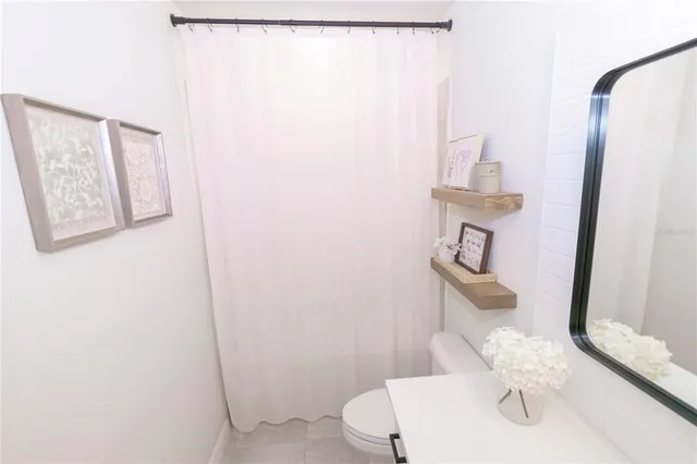 a bathroom with a sink toilet and mirror