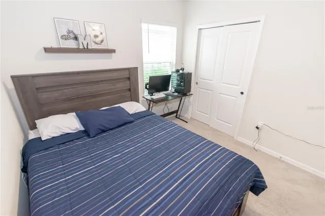 a living room with a bed furniture and a window