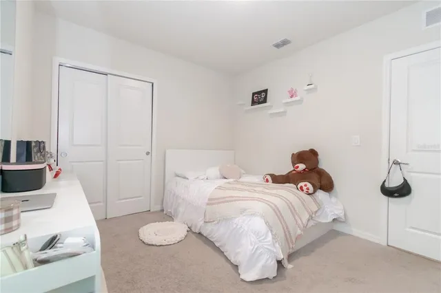 a bedroom with a bed and a couch