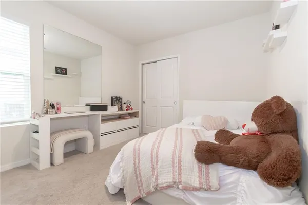 a bedroom with a bed and a couch