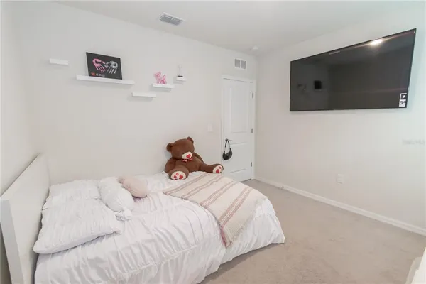a bedroom with a bed and a flat screen tv