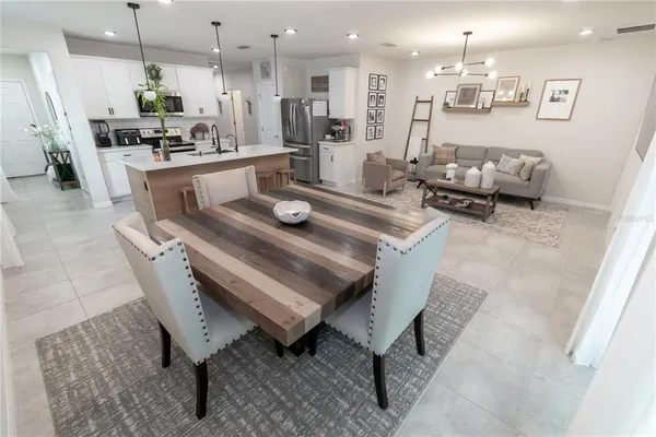 a large kitchen with a table and chairs