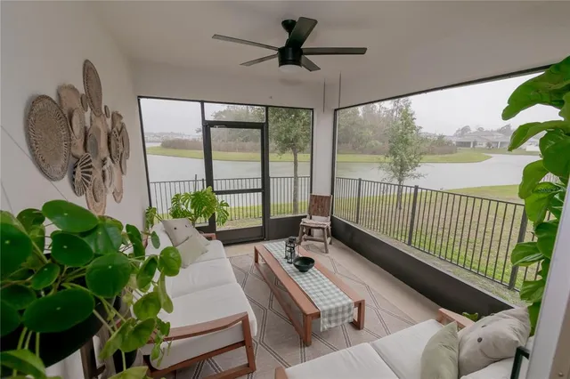 a living room with patio furniture and a potted plant